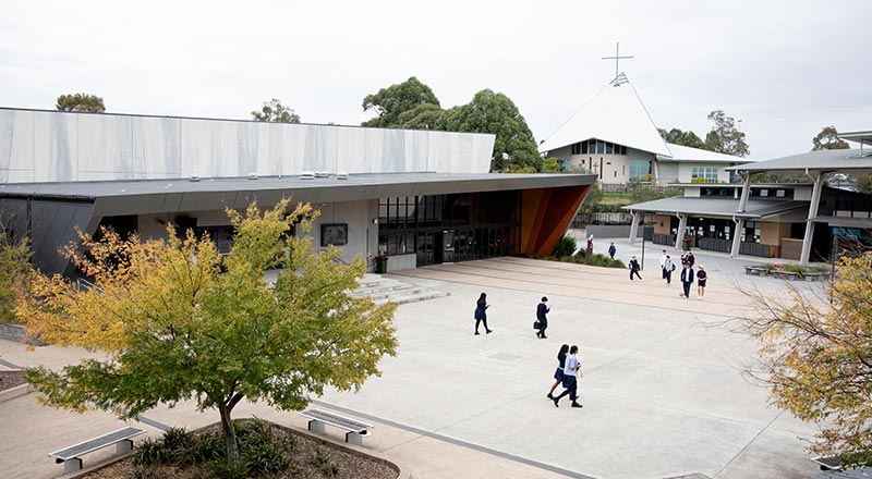 St John XXIII Stanhope Gardens. Students are walking outside in the school grounds.