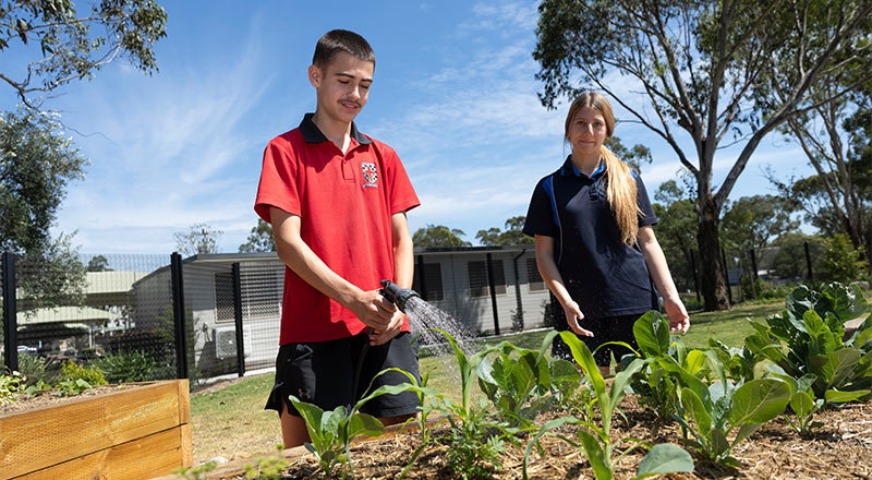Marist Learning Zone. Students watering garden.