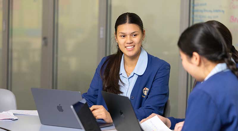 Cerdon College students on MacBook laptops