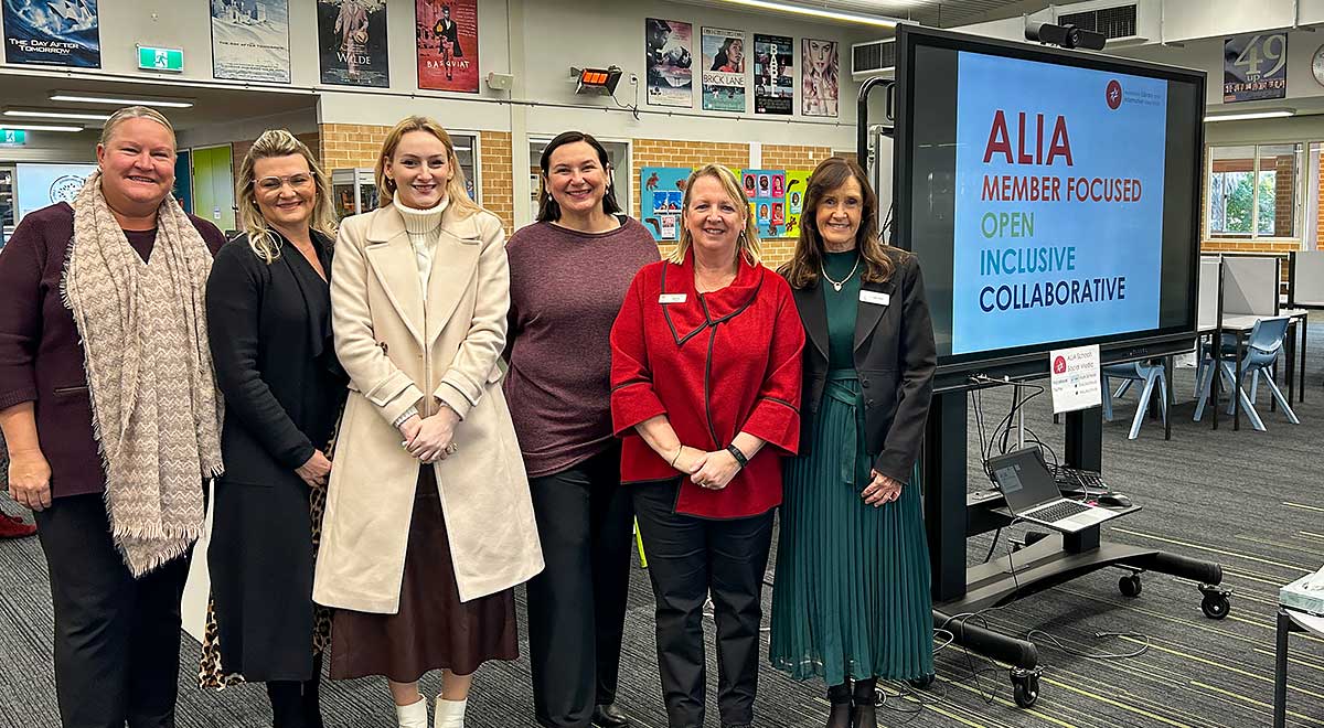 CSPD Teacher librarians posed in front of the ALIA sign at the seminar about artificial intelligence (AI)