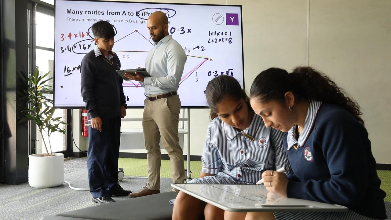 Master maths teacher Vikesh Gami teaching maths to high school students at John XXII Catholic College in Sydney