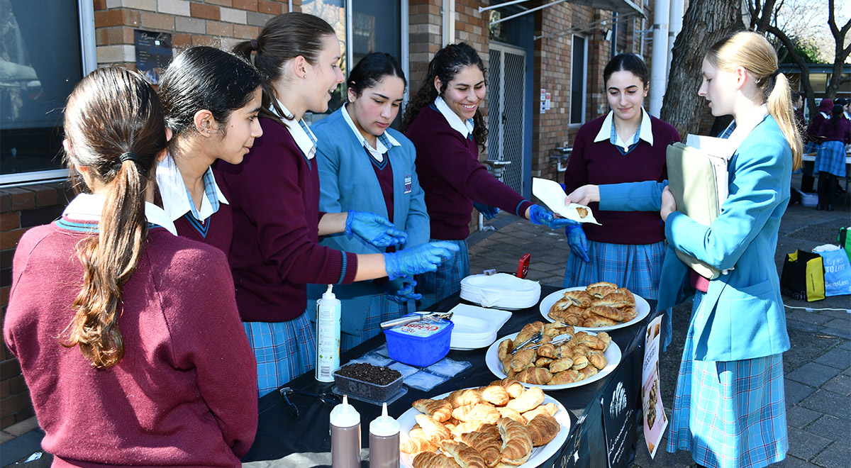 Students purchasing something from a market day stall
