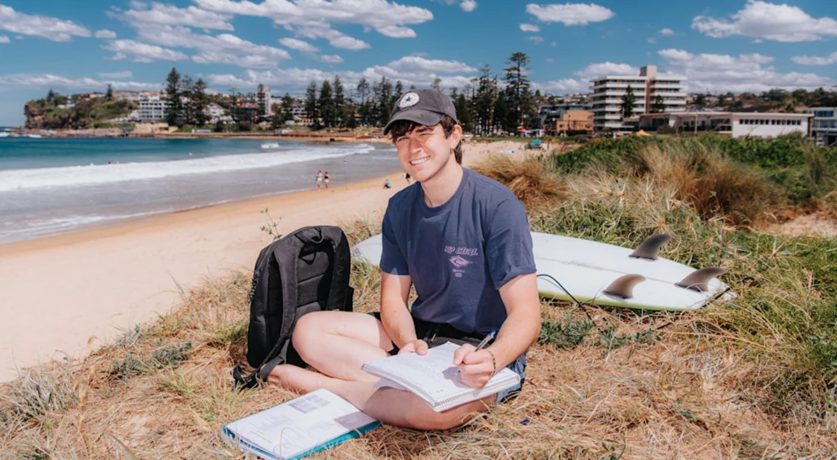 Thanos Kingsley is a year 12 student from Parramatta Marist High School. He likes to study down at Dee Why beach and take a break for surfing every now and again. Credit: James Brickwood