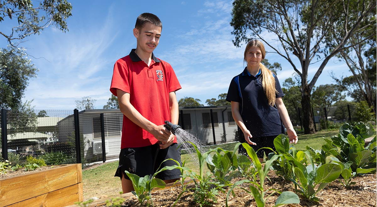 Marist Learning Zone students watering garden
