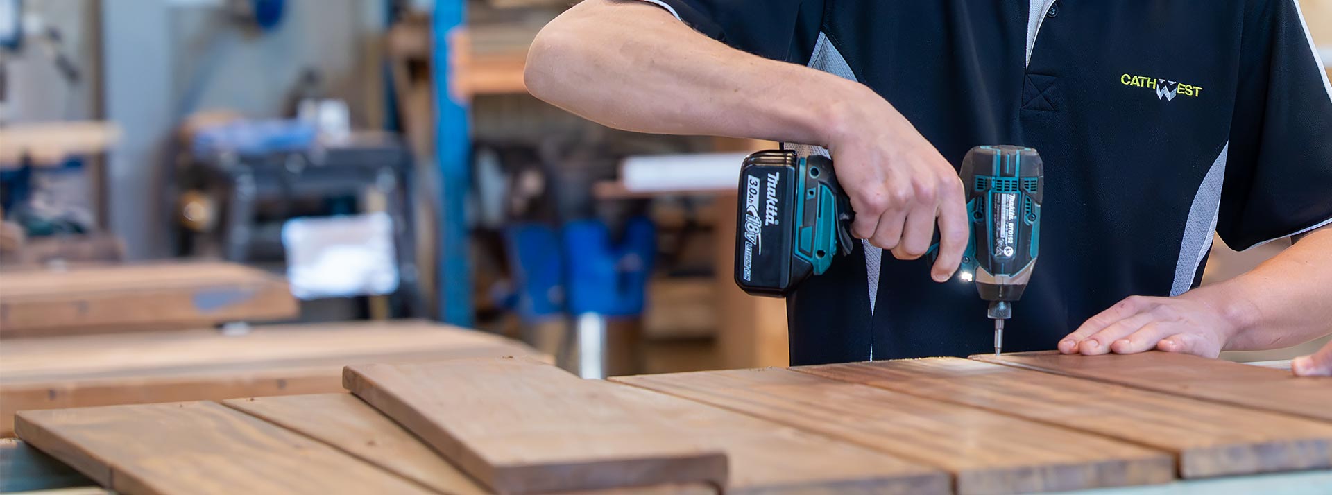 Kalan Markson, Cathwest student, drilling into wooden planks as part of his carpentry classes